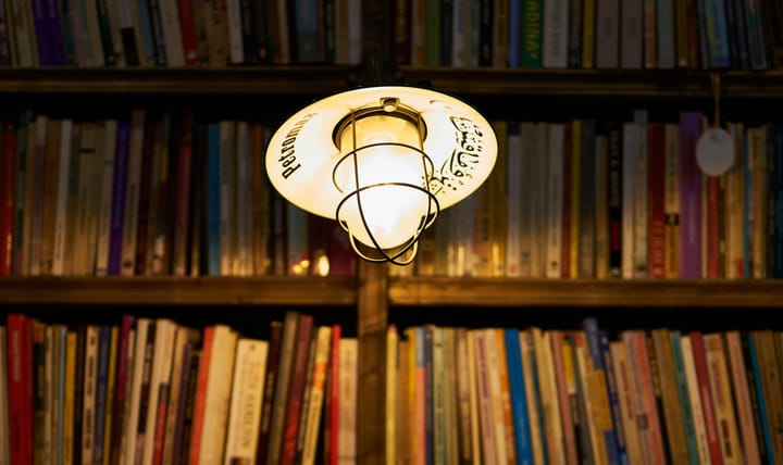 Light bulb illuminating a library. Credit to engin akyurt. Downloaded from Unsplash.com
