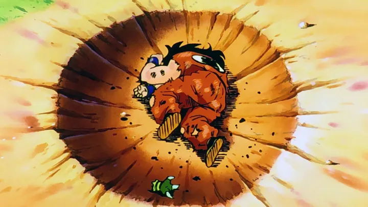 A screen capture of Yamcha in his iconic death pose, lying dead in a crater from the animated series, Dragon Ball Z